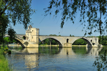 Unfinished bridge in Avignon with reflection in river