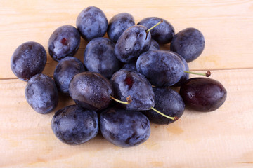 Blue plums on table