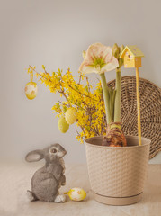 Blooming hippeastrum (amaryllis) and a figurine of a rabbit  (mass production)