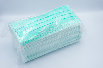 Green face mask pack for wholesale isolated on white background - COVID19 protection concept