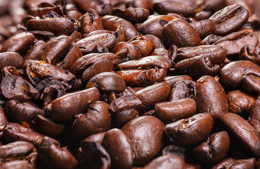 Close up to a heap of coffee beans.
Macro photography of fresh roasted coffee beans high resolution. Detailed macro picture on roasted coffee beans.  Close-up of brown coffee beans background  image