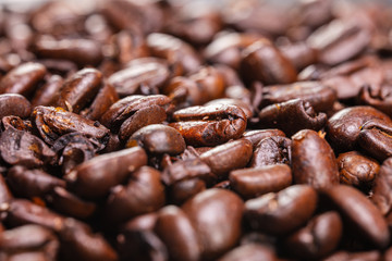 Close up to a heap of coffee beans.
Macro photography of fresh roasted coffee beans high resolution. Detailed macro picture on roasted coffee beans.  Close-up of brown coffee beans background  image
