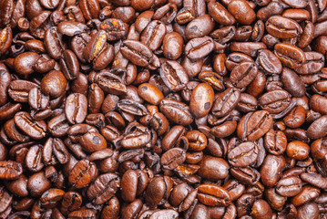 Close up to a heap of coffee beans.
Macro photography of fresh roasted coffee beans high resolution. Detailed macro picture on roasted coffee beans.  Close-up of brown coffee beans background  image