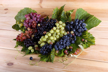 Grape and leaves on table