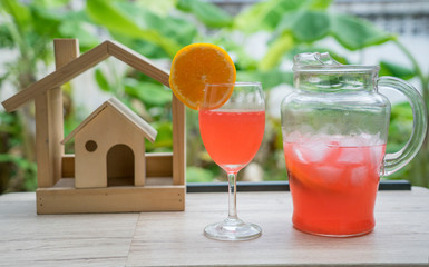 At home, make a cocktail, drink with oranges, lemons and soda.