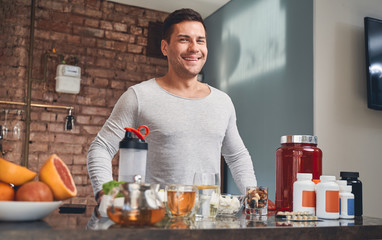 Sportive Caucasian man standing in the kitchen