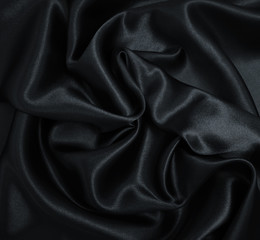 Fototapeta premium Smooth elegant black silk or satin texture as abstract background. Luxurious background design
