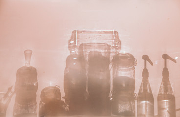 Conceptual photo showing the silhouettes of glass bottle containers to show concept of sanitation, infection control and good hygiene to fight the spread of covid-19 pandemic