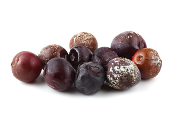 Rotten plums isolated on white