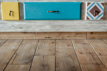 multi-colored wooden drawers with handles in the wall