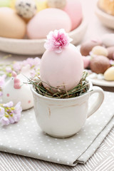 Obraz na płótnie Canvas Easter egg in ceramic cup. Simple table decoration.