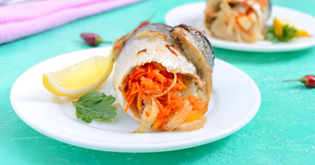 Baked herring stuffed with vegetables. Tasty fish rolls.