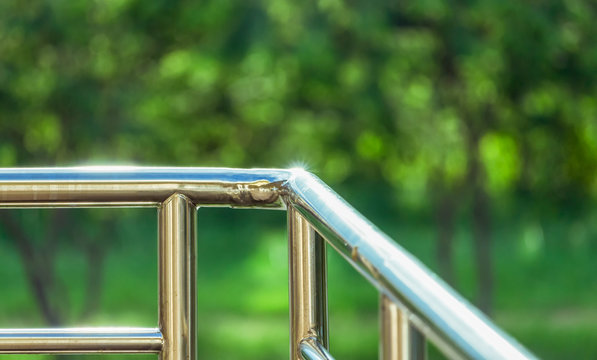 Stainless Railing With Blurry Green Nature Background