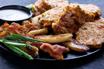 sweet corn pancakes with fried banana, bacon