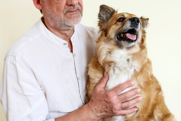 The man is stroking his beautiful dog.