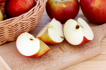 Basket with apples on wooden table