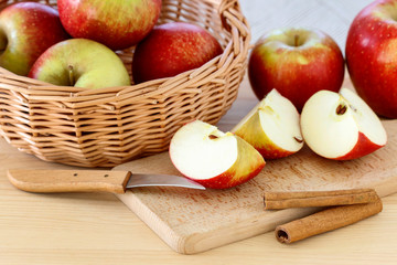 Basket with apples on wooden table
