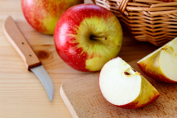 Basket with apples on wooden table
