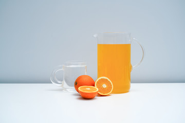 A glass of orange juice on the white table. A healthy and delicious orange juice.