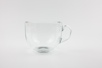 Transparent drink mug on a white background. For the presentation of something empty and transparent. Loneliness.