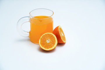 A glass of orange juice on the white table. A healthy and delicious orange juice.
