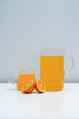 A glass of orange juice on the white table. A healthy and delicious orange juice.
