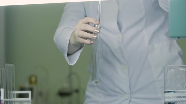 The operator measuring a sample of water or solution in a chemical laboratory in a medical solution factory. close up medical industry