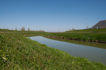 Meadow with a blue lake in the center