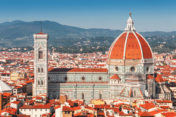 Fototapeta na wymiar Santa Maria del Fiore is the main attraction and business card of Florence. Aerial view of the Cathedral and city roofs