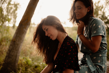Fototapeta premium Two young women embraced on the field