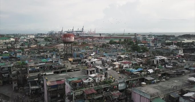 Aerial flight over poor housing area towards the sea, Tondo, Manila, Philippines 