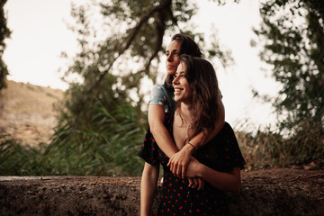 Two young women embraced on the field