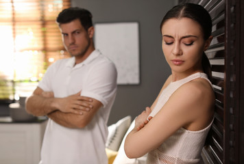 Fototapeta premium Couple quarreling due to jealousy in relationship at home