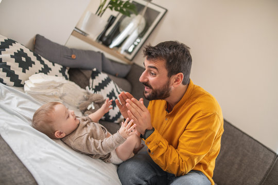 Father And Baby.Young Dad Is Changing Baby Diaper.