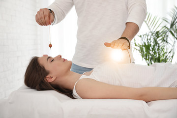 Young woman during crystal healing session in therapy room