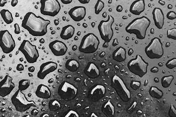 black drops of water on a dark surface