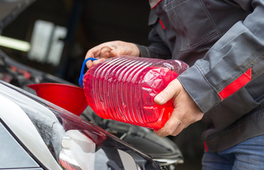 The Replacing fluids in a car mechanic