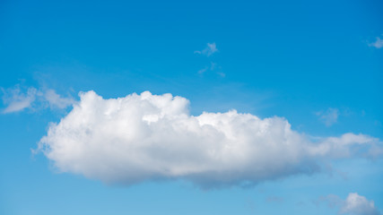 Fluffy cloud and a blue sky background