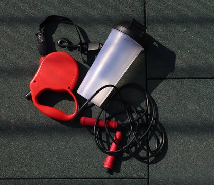 Dog Leash, Glass And Jump Rope On A Sports Background