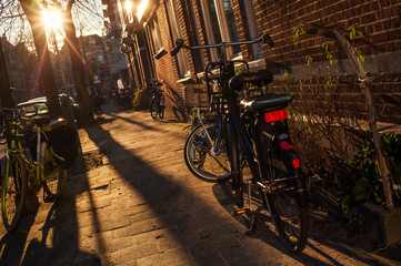 Old holland vintage classic bicycle on street at sunrise or sunset. Cityscape view. Dutch lifestyle