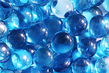 Blue glass spheres background. Closeup macro abstract