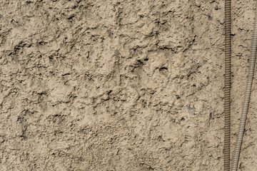 Corrugated wires on the background of a rough stone wall