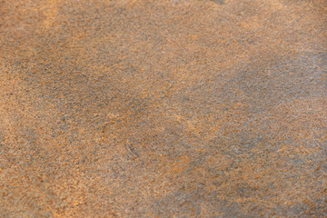 The metal surface is covered with corrosion, soft focus