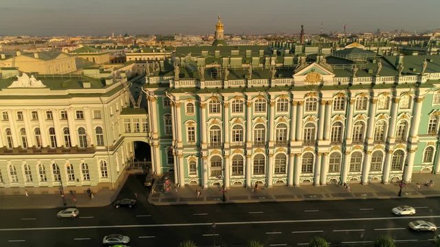 Flight sideways Hermitage Imperial Winter Palace baroque style details facade sculpture St. Petersburg Russia unique showplace historical monument. Central cityscape. People walk. Road traffic. Aerial