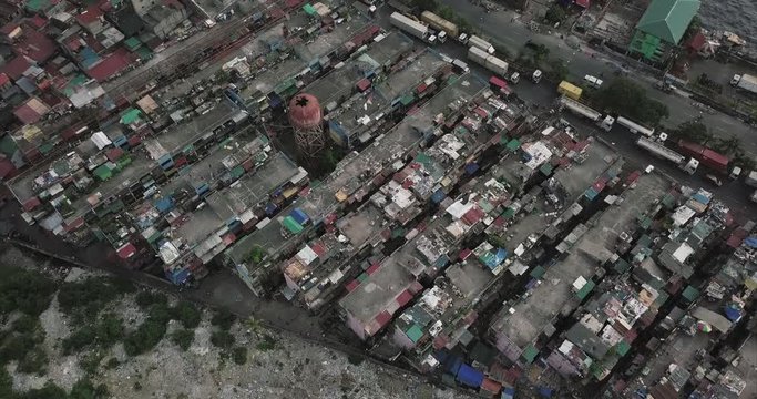 Descending aerial flight over poor housing tilting up revealing harbour, Tondo, Manila, Philippines