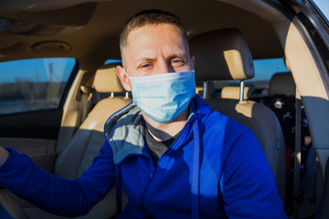 Man in the medical mask in car. coronavirus, disease, infection, quarantine, covid-19