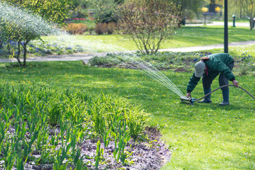 Girl with an automatic irrigation system equipment garden watering tool