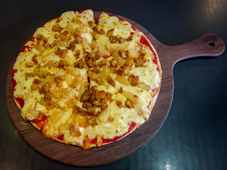 homemade meat pizza on a wooden tray close-up