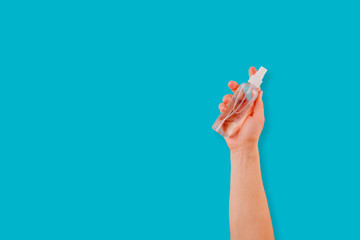 Coronavirus. Cleaning woman hands with sanitizer spray on blue background