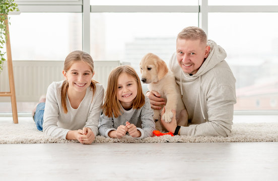 Father with daughters and puppy